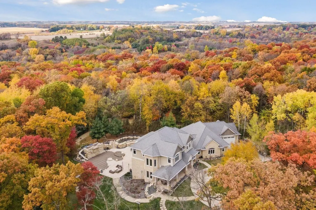 5790 Jasmine Lane SW Home in Rochester, Minnesota. Discover unparalleled luxury in this 11,000 SF architectural masterpiece by renowned architect John McMiller. Nestled on a private lot, this smart home is a blend of elegance and technology, featuring a pool deck, theater room, and heated floors throughout.
