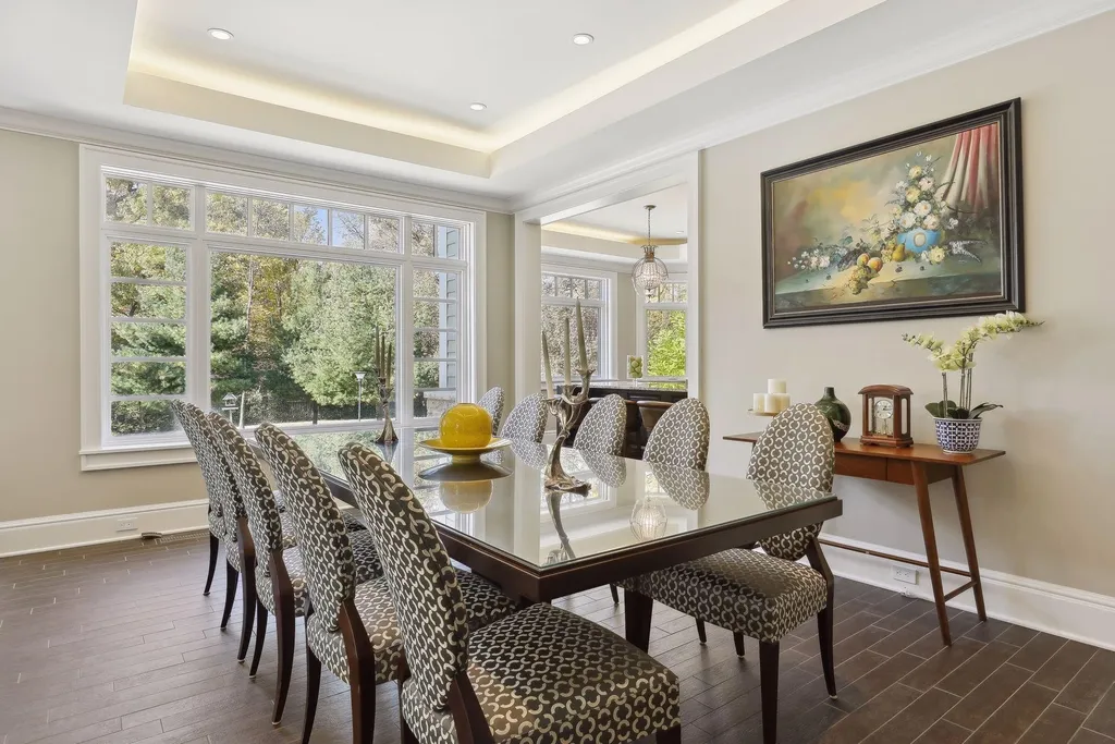5790 Jasmine Lane SW Home in Rochester, Minnesota. Discover unparalleled luxury in this 11,000 SF architectural masterpiece by renowned architect John McMiller. Nestled on a private lot, this smart home is a blend of elegance and technology, featuring a pool deck, theater room, and heated floors throughout.