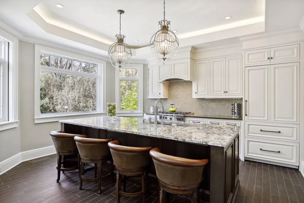 5790 Jasmine Lane SW Home in Rochester, Minnesota. Discover unparalleled luxury in this 11,000 SF architectural masterpiece by renowned architect John McMiller. Nestled on a private lot, this smart home is a blend of elegance and technology, featuring a pool deck, theater room, and heated floors throughout.