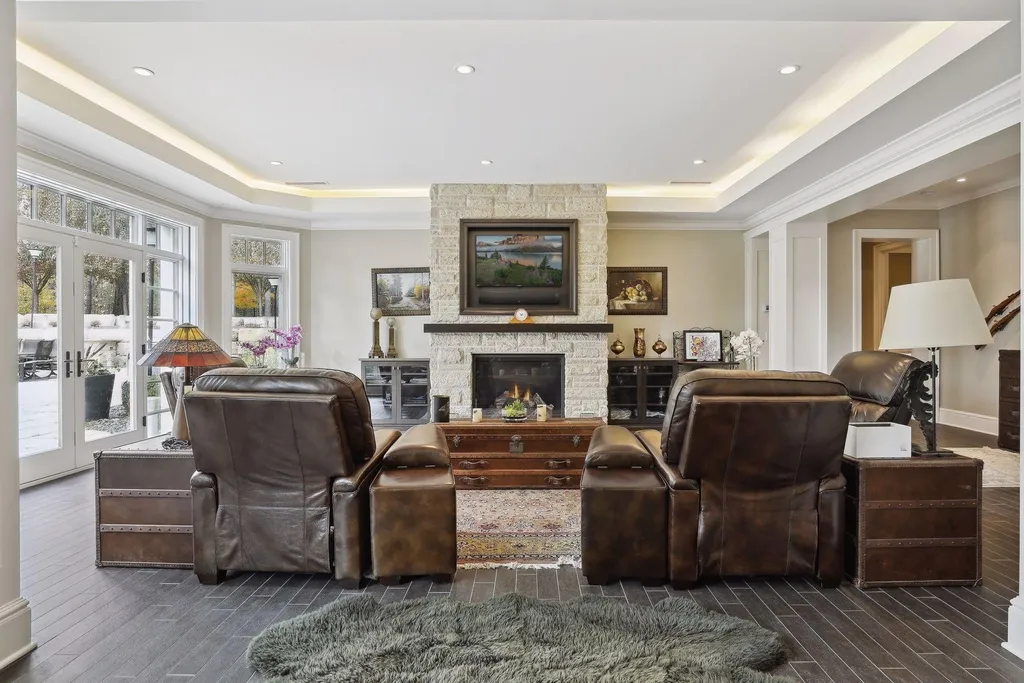 5790 Jasmine Lane SW Home in Rochester, Minnesota. Discover unparalleled luxury in this 11,000 SF architectural masterpiece by renowned architect John McMiller. Nestled on a private lot, this smart home is a blend of elegance and technology, featuring a pool deck, theater room, and heated floors throughout.