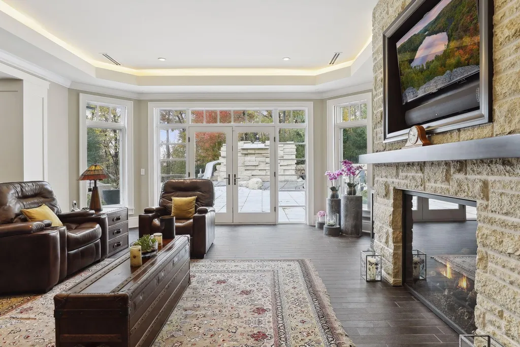 5790 Jasmine Lane SW Home in Rochester, Minnesota. Discover unparalleled luxury in this 11,000 SF architectural masterpiece by renowned architect John McMiller. Nestled on a private lot, this smart home is a blend of elegance and technology, featuring a pool deck, theater room, and heated floors throughout.