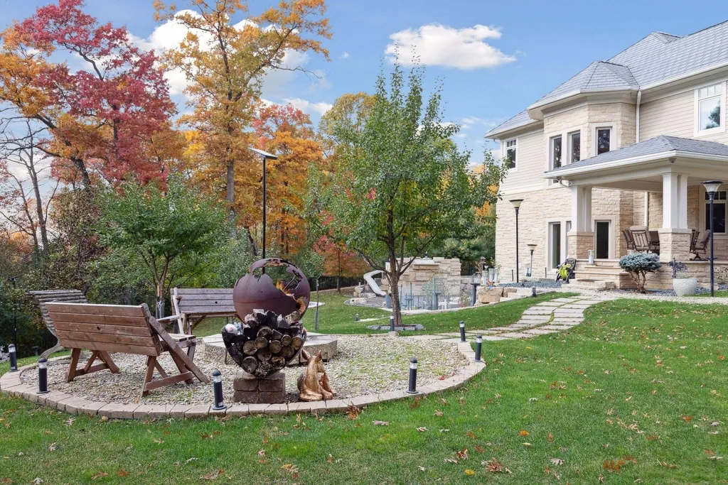 5790 Jasmine Lane SW Home in Rochester, Minnesota. Discover unparalleled luxury in this 11,000 SF architectural masterpiece by renowned architect John McMiller. Nestled on a private lot, this smart home is a blend of elegance and technology, featuring a pool deck, theater room, and heated floors throughout.