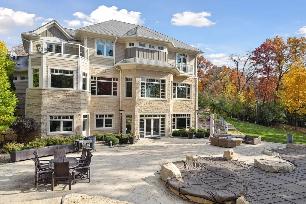 5790 Jasmine Lane SW Home in Rochester, Minnesota. Discover unparalleled luxury in this 11,000 SF architectural masterpiece by renowned architect John McMiller. Nestled on a private lot, this smart home is a blend of elegance and technology, featuring a pool deck, theater room, and heated floors throughout.