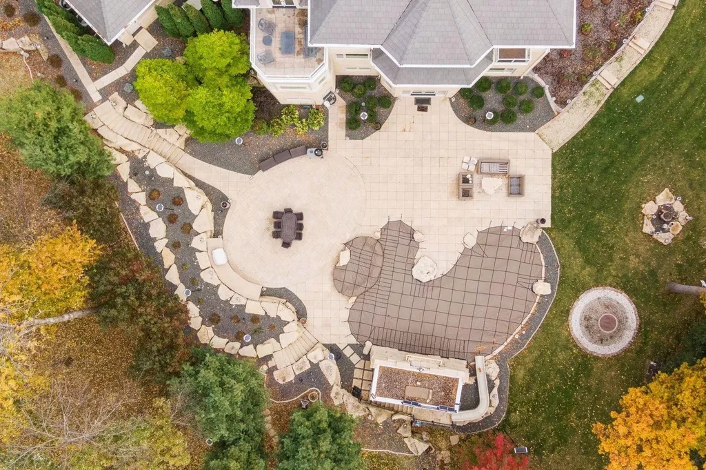 5790 Jasmine Lane SW Home in Rochester, Minnesota. Discover unparalleled luxury in this 11,000 SF architectural masterpiece by renowned architect John McMiller. Nestled on a private lot, this smart home is a blend of elegance and technology, featuring a pool deck, theater room, and heated floors throughout.