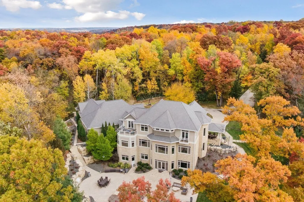 5790 Jasmine Lane SW Home in Rochester, Minnesota. Discover unparalleled luxury in this 11,000 SF architectural masterpiece by renowned architect John McMiller. Nestled on a private lot, this smart home is a blend of elegance and technology, featuring a pool deck, theater room, and heated floors throughout.