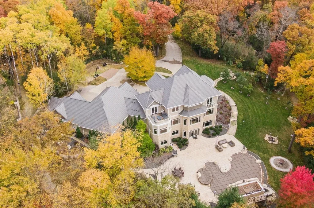 5790 Jasmine Lane SW Home in Rochester, Minnesota. Discover unparalleled luxury in this 11,000 SF architectural masterpiece by renowned architect John McMiller. Nestled on a private lot, this smart home is a blend of elegance and technology, featuring a pool deck, theater room, and heated floors throughout.
