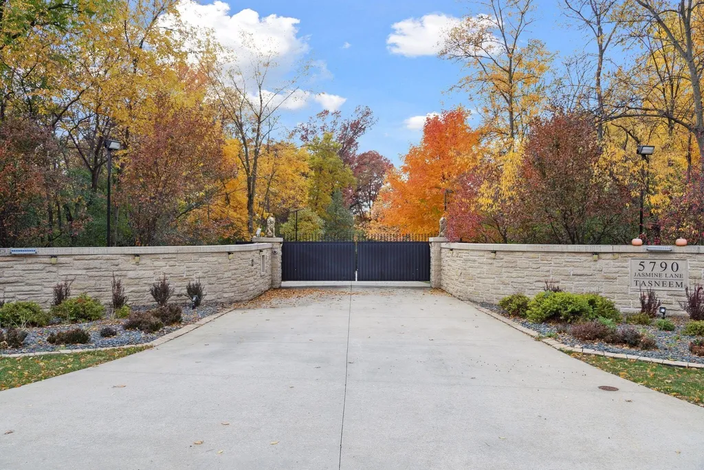 5790 Jasmine Lane SW Home in Rochester, Minnesota. Discover unparalleled luxury in this 11,000 SF architectural masterpiece by renowned architect John McMiller. Nestled on a private lot, this smart home is a blend of elegance and technology, featuring a pool deck, theater room, and heated floors throughout.