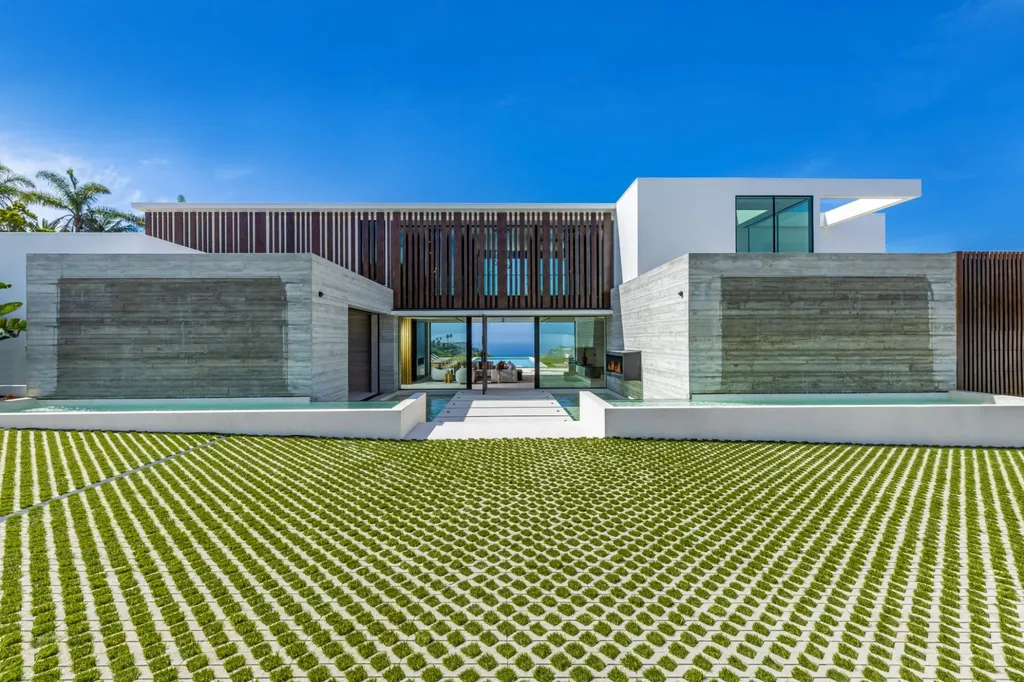6889 Dume Drive Home in Malibu, California. Immerse yourself in the epitome of Malibu living with this newly completed 8,500 SF modern organic retreat in Little Dume. Developed and designed by Charles Kotliar and architect Doug Burdge, this ocean-view oasis offers 6 BD, 8 BA, customizations like board form concrete walls, oak woods, and curated stones. 