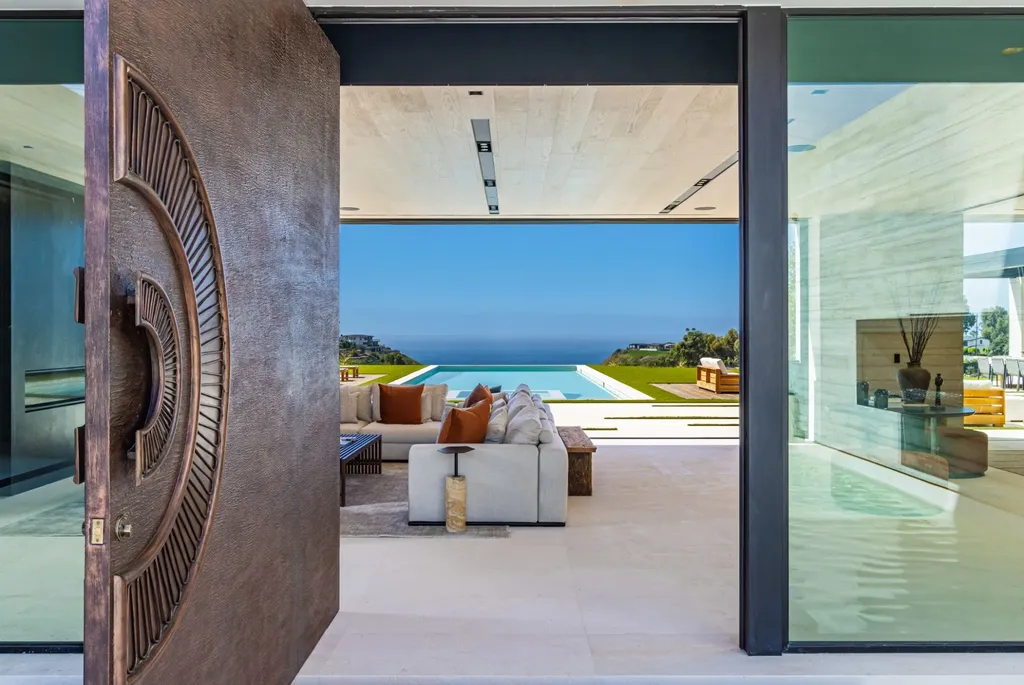 6889 Dume Drive Home in Malibu, California. Immerse yourself in the epitome of Malibu living with this newly completed 8,500 SF modern organic retreat in Little Dume. Developed and designed by Charles Kotliar and architect Doug Burdge, this ocean-view oasis offers 6 BD, 8 BA, customizations like board form concrete walls, oak woods, and curated stones. 