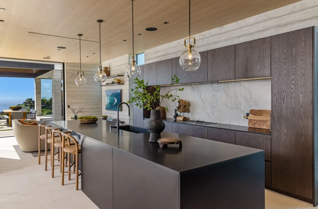 6889 Dume Drive Home in Malibu, California. Immerse yourself in the epitome of Malibu living with this newly completed 8,500 SF modern organic retreat in Little Dume. Developed and designed by Charles Kotliar and architect Doug Burdge, this ocean-view oasis offers 6 BD, 8 BA, customizations like board form concrete walls, oak woods, and curated stones. 