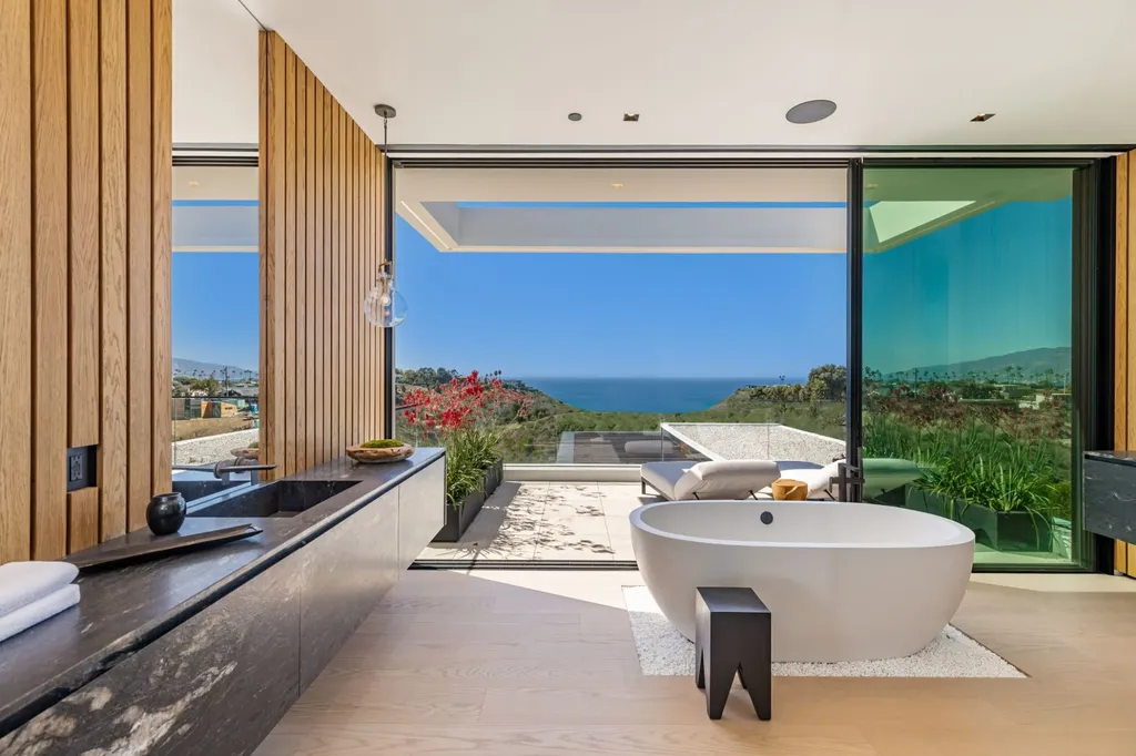 6889 Dume Drive Home in Malibu, California. Immerse yourself in the epitome of Malibu living with this newly completed 8,500 SF modern organic retreat in Little Dume. Developed and designed by Charles Kotliar and architect Doug Burdge, this ocean-view oasis offers 6 BD, 8 BA, customizations like board form concrete walls, oak woods, and curated stones. 