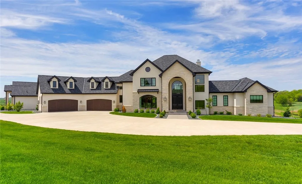 7280 Eldorado Point Home in West Des Moines, Iowa. This custom estate on 7 acres offers unparalleled privacy and stunning views. The 2-story great room, gourmet chef's kitchen, and spa-like primary suite are just the beginning. With a loft area, lower level entertainment space, and a 5,686 sq ft gym for fitness and fun, this home is designed for luxury living. 