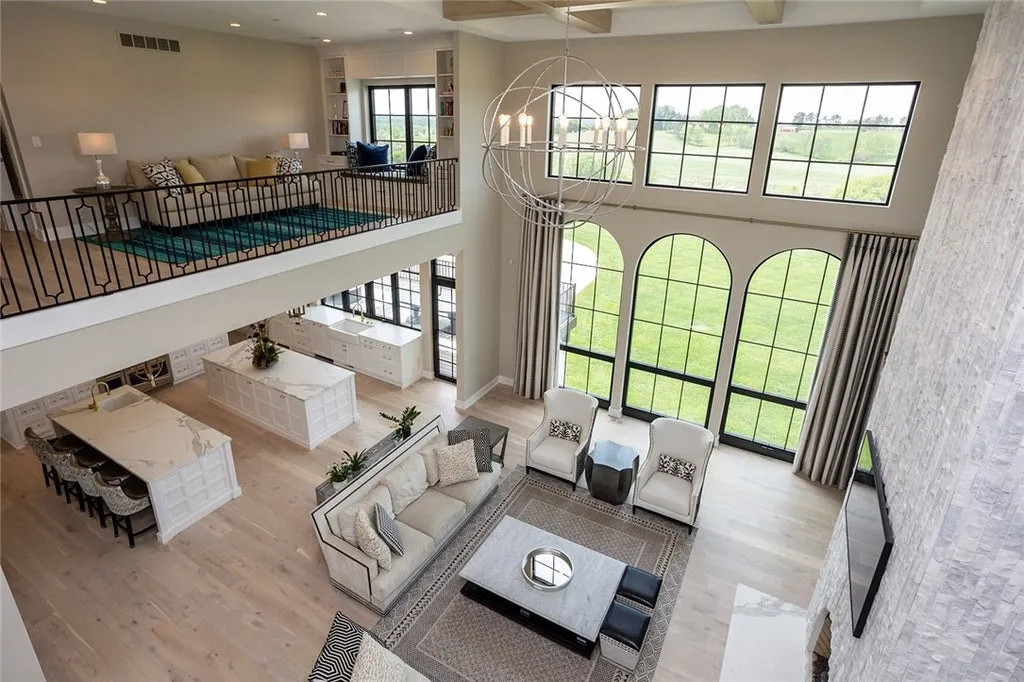 7280 Eldorado Point Home in West Des Moines, Iowa. This custom estate on 7 acres offers unparalleled privacy and stunning views. The 2-story great room, gourmet chef's kitchen, and spa-like primary suite are just the beginning. With a loft area, lower level entertainment space, and a 5,686 sq ft gym for fitness and fun, this home is designed for luxury living. 
