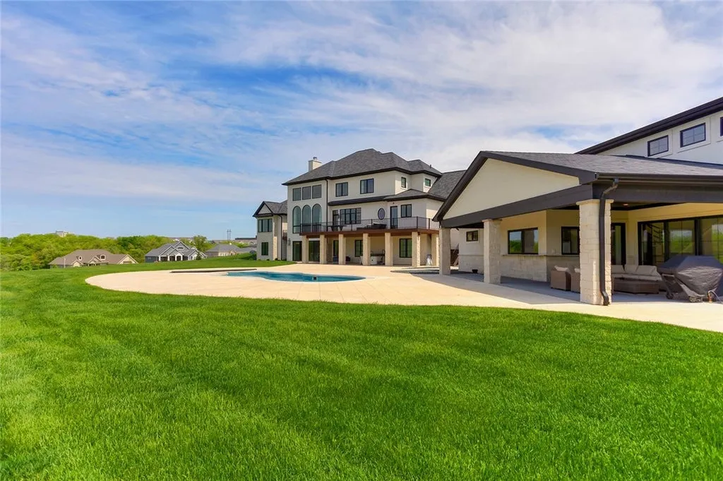 7280 Eldorado Point Home in West Des Moines, Iowa. This custom estate on 7 acres offers unparalleled privacy and stunning views. The 2-story great room, gourmet chef's kitchen, and spa-like primary suite are just the beginning. With a loft area, lower level entertainment space, and a 5,686 sq ft gym for fitness and fun, this home is designed for luxury living. 