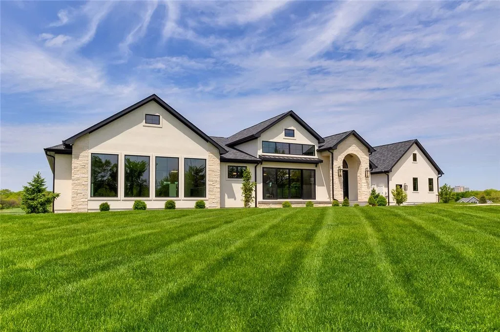 7280 Eldorado Point Home in West Des Moines, Iowa. This custom estate on 7 acres offers unparalleled privacy and stunning views. The 2-story great room, gourmet chef's kitchen, and spa-like primary suite are just the beginning. With a loft area, lower level entertainment space, and a 5,686 sq ft gym for fitness and fun, this home is designed for luxury living. 