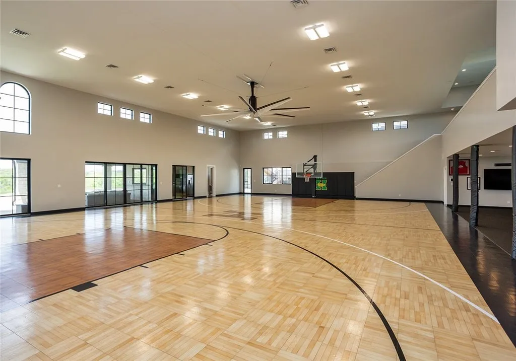 7280 Eldorado Point Home in West Des Moines, Iowa. This custom estate on 7 acres offers unparalleled privacy and stunning views. The 2-story great room, gourmet chef's kitchen, and spa-like primary suite are just the beginning. With a loft area, lower level entertainment space, and a 5,686 sq ft gym for fitness and fun, this home is designed for luxury living. 