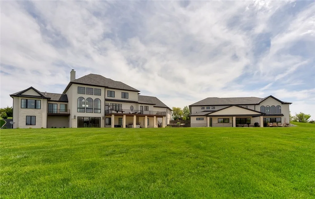 7280 Eldorado Point Home in West Des Moines, Iowa. This custom estate on 7 acres offers unparalleled privacy and stunning views. The 2-story great room, gourmet chef's kitchen, and spa-like primary suite are just the beginning. With a loft area, lower level entertainment space, and a 5,686 sq ft gym for fitness and fun, this home is designed for luxury living. 