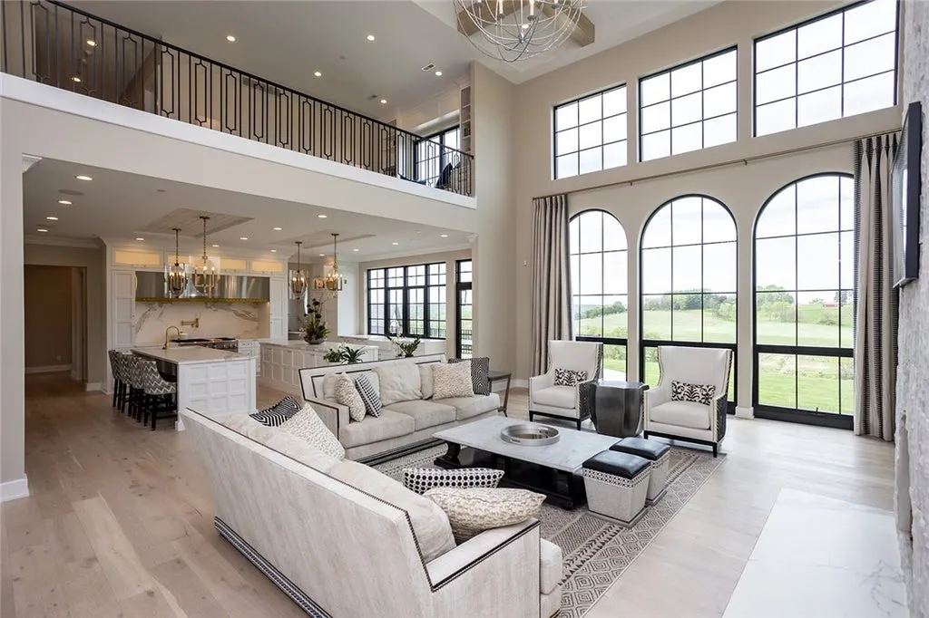 7280 Eldorado Point Home in West Des Moines, Iowa. This custom estate on 7 acres offers unparalleled privacy and stunning views. The 2-story great room, gourmet chef's kitchen, and spa-like primary suite are just the beginning. With a loft area, lower level entertainment space, and a 5,686 sq ft gym for fitness and fun, this home is designed for luxury living. 