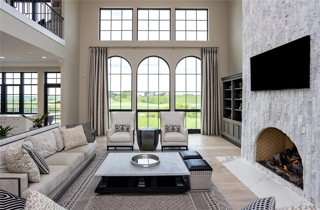 7280 Eldorado Point Home in West Des Moines, Iowa. This custom estate on 7 acres offers unparalleled privacy and stunning views. The 2-story great room, gourmet chef's kitchen, and spa-like primary suite are just the beginning. With a loft area, lower level entertainment space, and a 5,686 sq ft gym for fitness and fun, this home is designed for luxury living. 