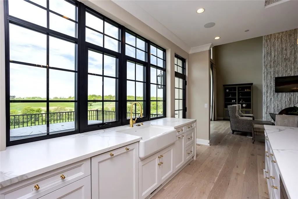 7280 Eldorado Point Home in West Des Moines, Iowa. This custom estate on 7 acres offers unparalleled privacy and stunning views. The 2-story great room, gourmet chef's kitchen, and spa-like primary suite are just the beginning. With a loft area, lower level entertainment space, and a 5,686 sq ft gym for fitness and fun, this home is designed for luxury living. 
