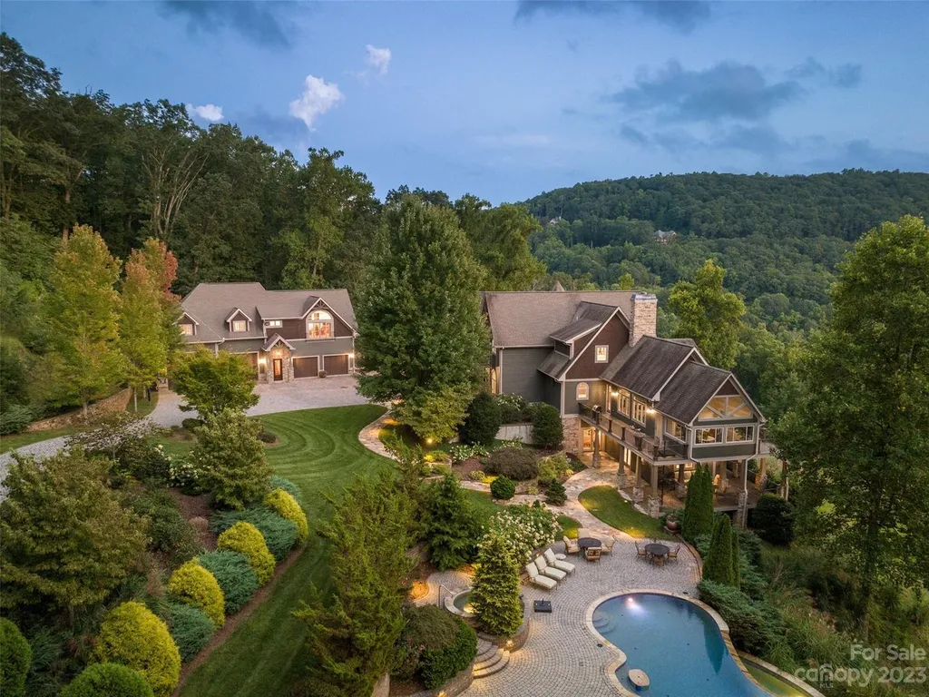 73 Crestridge Drive Home in Asheville, North Carolina. Discover the pinnacle of mountain living in this 7,000+ SF estate within the exclusive gated community of Poplar Ridge. Enjoy breathtaking long-range mountain views from the multi-level deck, infinity-edge pool, and hot tub. The main house features an updated kitchen, four new baths, terrace-level home theater, wine room, and more. 