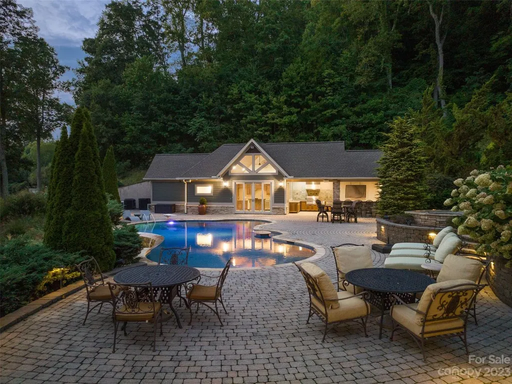 73 Crestridge Drive Home in Asheville, North Carolina. Discover the pinnacle of mountain living in this 7,000+ SF estate within the exclusive gated community of Poplar Ridge. Enjoy breathtaking long-range mountain views from the multi-level deck, infinity-edge pool, and hot tub. The main house features an updated kitchen, four new baths, terrace-level home theater, wine room, and more. 