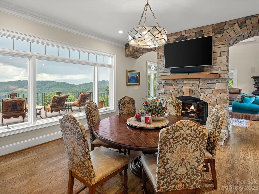 73 Crestridge Drive Home in Asheville, North Carolina. Discover the pinnacle of mountain living in this 7,000+ SF estate within the exclusive gated community of Poplar Ridge. Enjoy breathtaking long-range mountain views from the multi-level deck, infinity-edge pool, and hot tub. The main house features an updated kitchen, four new baths, terrace-level home theater, wine room, and more. 
