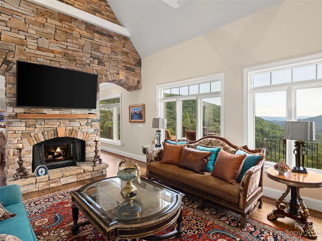 73 Crestridge Drive Home in Asheville, North Carolina. Discover the pinnacle of mountain living in this 7,000+ SF estate within the exclusive gated community of Poplar Ridge. Enjoy breathtaking long-range mountain views from the multi-level deck, infinity-edge pool, and hot tub. The main house features an updated kitchen, four new baths, terrace-level home theater, wine room, and more. 