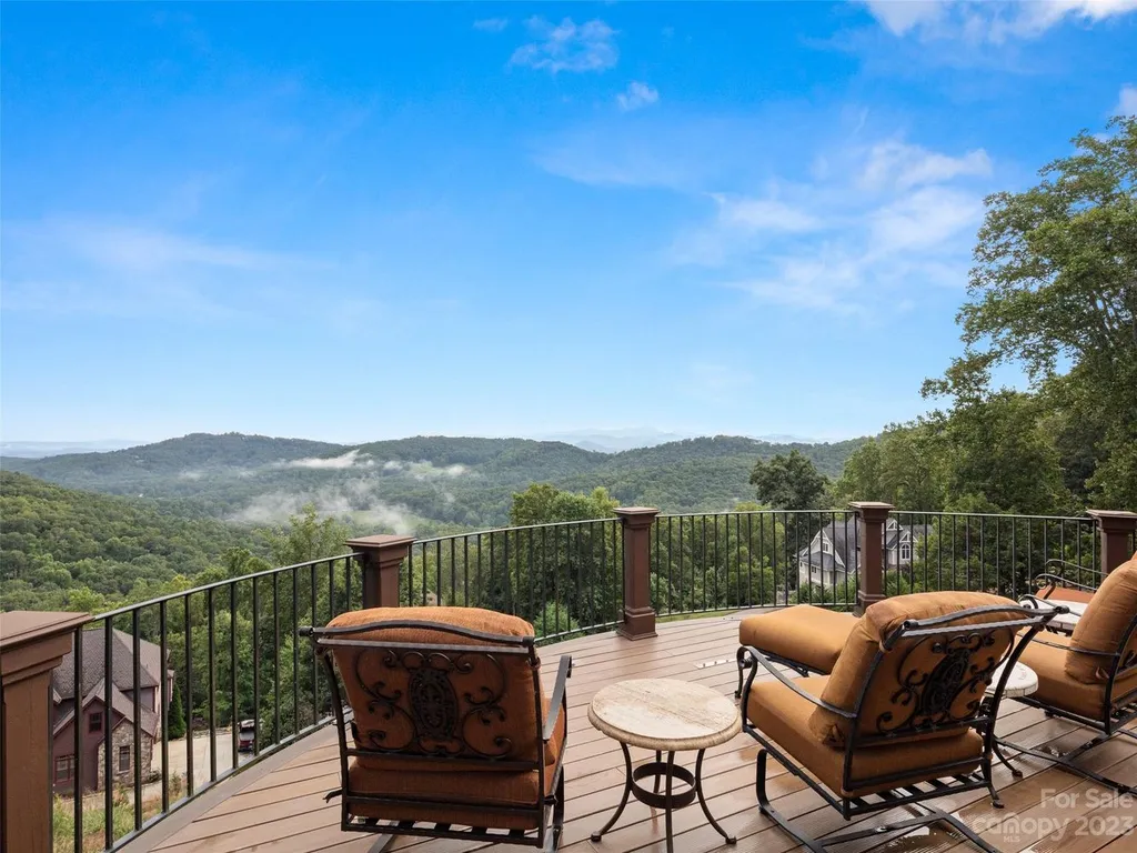 73 Crestridge Drive Home in Asheville, North Carolina. Discover the pinnacle of mountain living in this 7,000+ SF estate within the exclusive gated community of Poplar Ridge. Enjoy breathtaking long-range mountain views from the multi-level deck, infinity-edge pool, and hot tub. The main house features an updated kitchen, four new baths, terrace-level home theater, wine room, and more. 