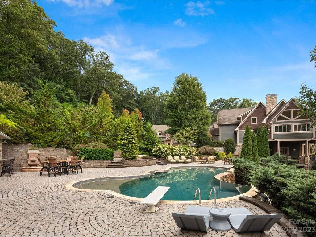 73 Crestridge Drive Home in Asheville, North Carolina. Discover the pinnacle of mountain living in this 7,000+ SF estate within the exclusive gated community of Poplar Ridge. Enjoy breathtaking long-range mountain views from the multi-level deck, infinity-edge pool, and hot tub. The main house features an updated kitchen, four new baths, terrace-level home theater, wine room, and more. 