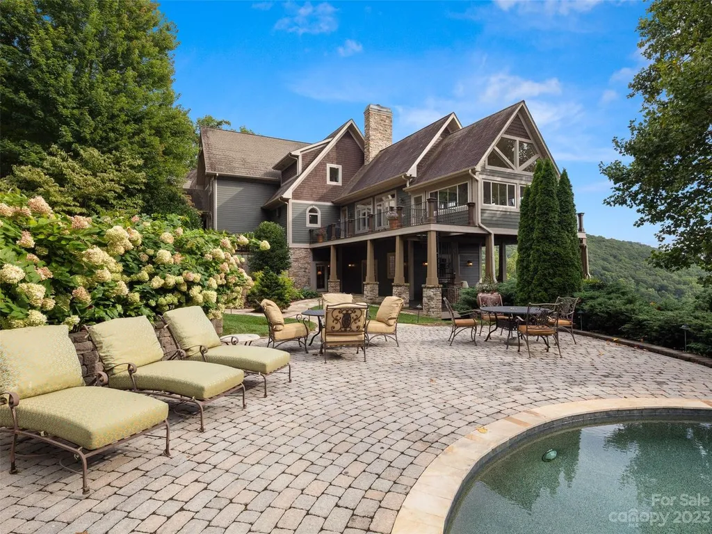 73 Crestridge Drive Home in Asheville, North Carolina. Discover the pinnacle of mountain living in this 7,000+ SF estate within the exclusive gated community of Poplar Ridge. Enjoy breathtaking long-range mountain views from the multi-level deck, infinity-edge pool, and hot tub. The main house features an updated kitchen, four new baths, terrace-level home theater, wine room, and more. 