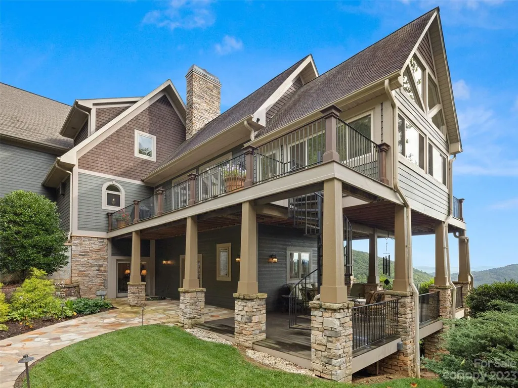 73 Crestridge Drive Home in Asheville, North Carolina. Discover the pinnacle of mountain living in this 7,000+ SF estate within the exclusive gated community of Poplar Ridge. Enjoy breathtaking long-range mountain views from the multi-level deck, infinity-edge pool, and hot tub. The main house features an updated kitchen, four new baths, terrace-level home theater, wine room, and more. 