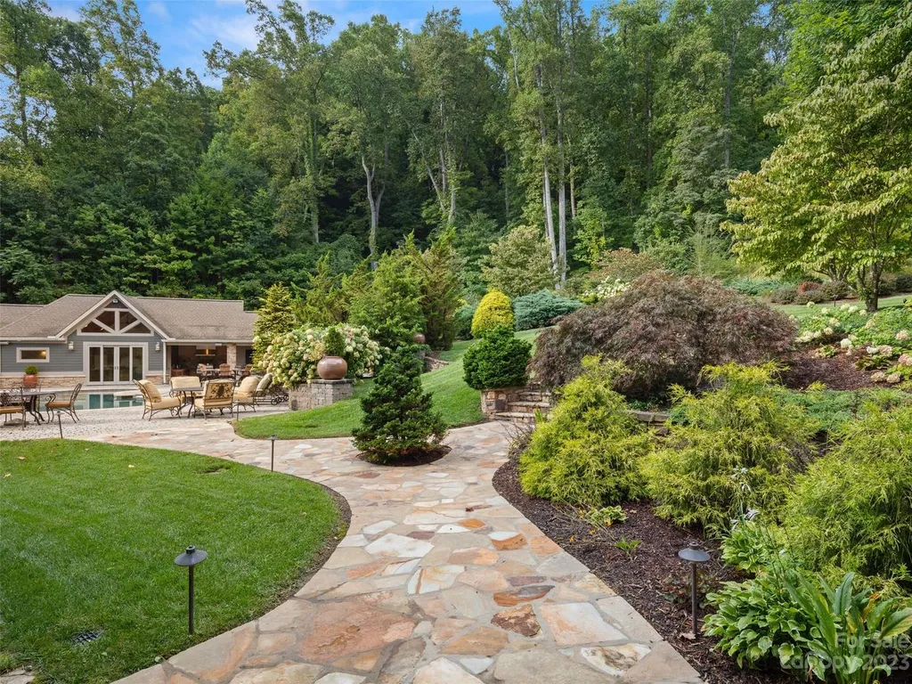 73 Crestridge Drive Home in Asheville, North Carolina. Discover the pinnacle of mountain living in this 7,000+ SF estate within the exclusive gated community of Poplar Ridge. Enjoy breathtaking long-range mountain views from the multi-level deck, infinity-edge pool, and hot tub. The main house features an updated kitchen, four new baths, terrace-level home theater, wine room, and more. 