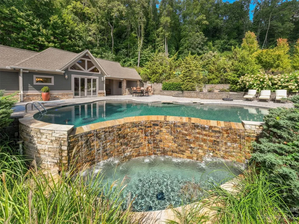 73 Crestridge Drive Home in Asheville, North Carolina. Discover the pinnacle of mountain living in this 7,000+ SF estate within the exclusive gated community of Poplar Ridge. Enjoy breathtaking long-range mountain views from the multi-level deck, infinity-edge pool, and hot tub. The main house features an updated kitchen, four new baths, terrace-level home theater, wine room, and more. 
