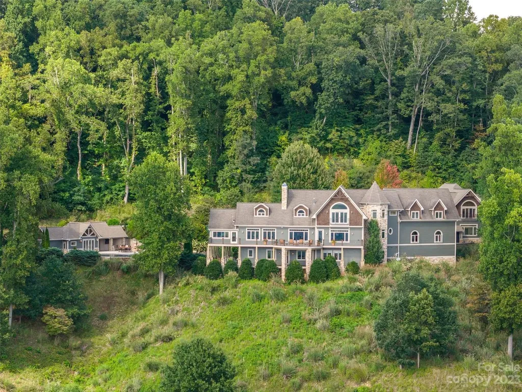 73 Crestridge Drive Home in Asheville, North Carolina. Discover the pinnacle of mountain living in this 7,000+ SF estate within the exclusive gated community of Poplar Ridge. Enjoy breathtaking long-range mountain views from the multi-level deck, infinity-edge pool, and hot tub. The main house features an updated kitchen, four new baths, terrace-level home theater, wine room, and more. 