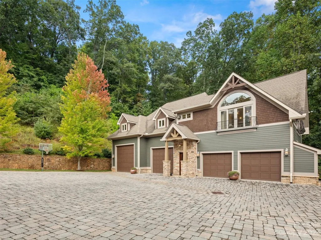 73 Crestridge Drive Home in Asheville, North Carolina. Discover the pinnacle of mountain living in this 7,000+ SF estate within the exclusive gated community of Poplar Ridge. Enjoy breathtaking long-range mountain views from the multi-level deck, infinity-edge pool, and hot tub. The main house features an updated kitchen, four new baths, terrace-level home theater, wine room, and more. 