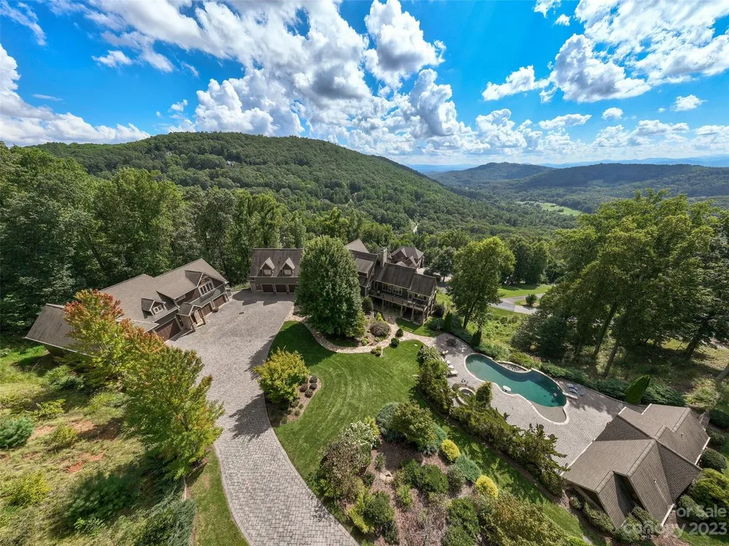 73 Crestridge Drive Home in Asheville, North Carolina. Discover the pinnacle of mountain living in this 7,000+ SF estate within the exclusive gated community of Poplar Ridge. Enjoy breathtaking long-range mountain views from the multi-level deck, infinity-edge pool, and hot tub. The main house features an updated kitchen, four new baths, terrace-level home theater, wine room, and more. 