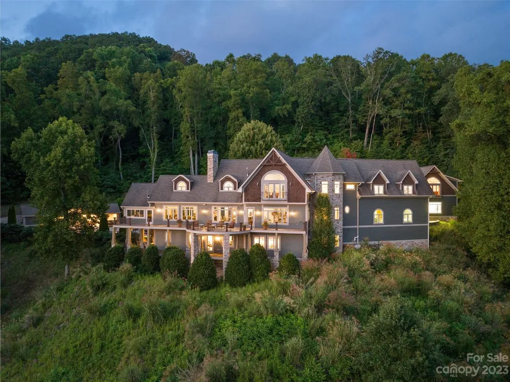 73 Crestridge Drive Home in Asheville, North Carolina. Discover the pinnacle of mountain living in this 7,000+ SF estate within the exclusive gated community of Poplar Ridge. Enjoy breathtaking long-range mountain views from the multi-level deck, infinity-edge pool, and hot tub. The main house features an updated kitchen, four new baths, terrace-level home theater, wine room, and more. 