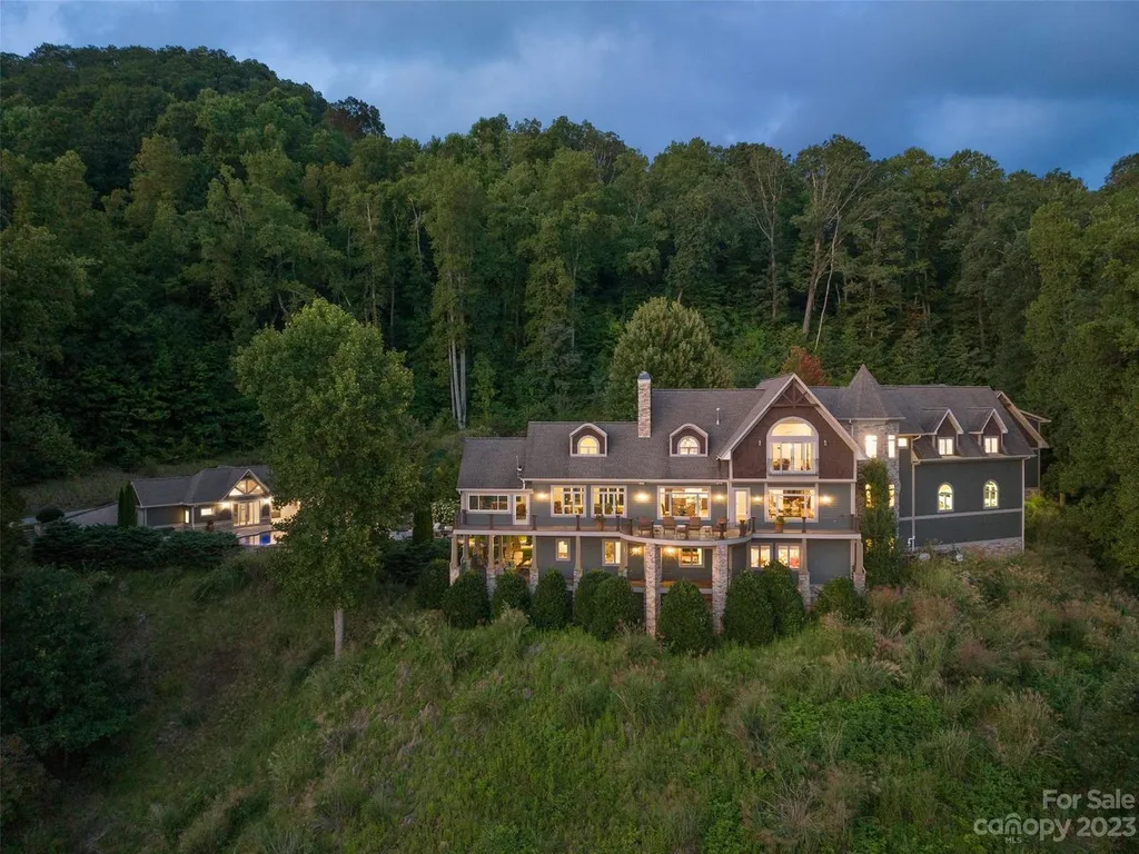 73 Crestridge Drive Home in Asheville, North Carolina. Discover the pinnacle of mountain living in this 7,000+ SF estate within the exclusive gated community of Poplar Ridge. Enjoy breathtaking long-range mountain views from the multi-level deck, infinity-edge pool, and hot tub. The main house features an updated kitchen, four new baths, terrace-level home theater, wine room, and more. 