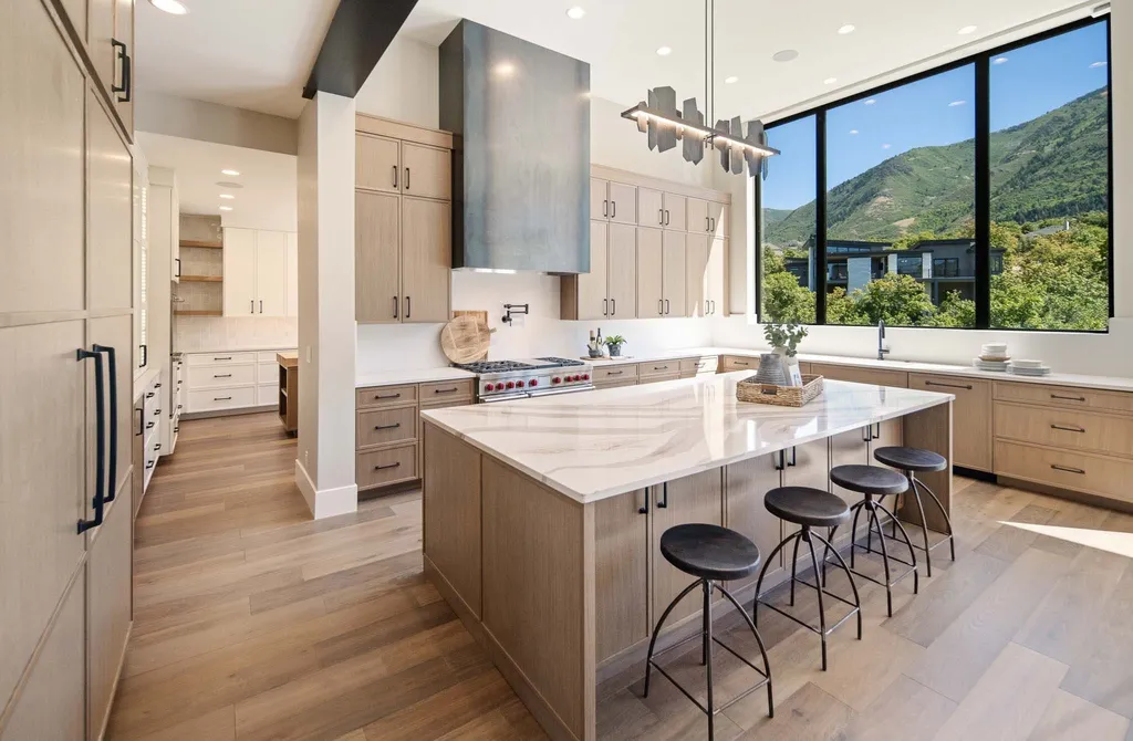927 South Summit Creek Drive Home in Woodland Hills, Utah. Step into your custom dream home in Summit Creek, offering luxury living and unparalleled natural beauty. This magnificent residence, spanning 8,043 square feet on a .90-acre lot, presents stunning views of mountains and valleys. Floor-to-ceiling windows bathe the open-concept interior in natural light and provide uninterrupted scenic views. 
