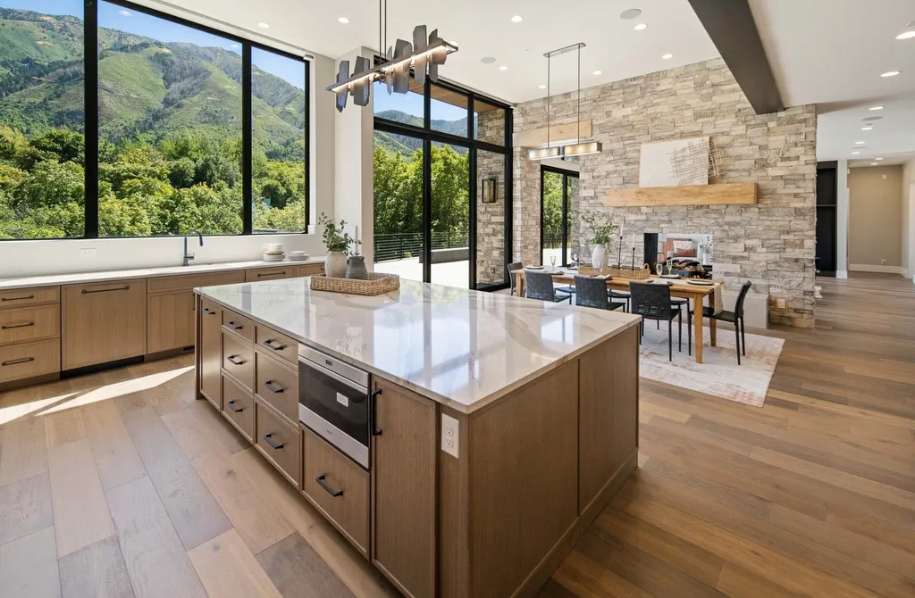 927 South Summit Creek Drive Home in Woodland Hills, Utah. Step into your custom dream home in Summit Creek, offering luxury living and unparalleled natural beauty. This magnificent residence, spanning 8,043 square feet on a .90-acre lot, presents stunning views of mountains and valleys. Floor-to-ceiling windows bathe the open-concept interior in natural light and provide uninterrupted scenic views. 
