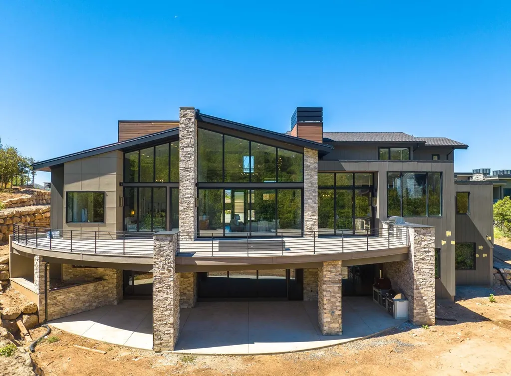 927 South Summit Creek Drive Home in Woodland Hills, Utah. Step into your custom dream home in Summit Creek, offering luxury living and unparalleled natural beauty. This magnificent residence, spanning 8,043 square feet on a .90-acre lot, presents stunning views of mountains and valleys. Floor-to-ceiling windows bathe the open-concept interior in natural light and provide uninterrupted scenic views. 