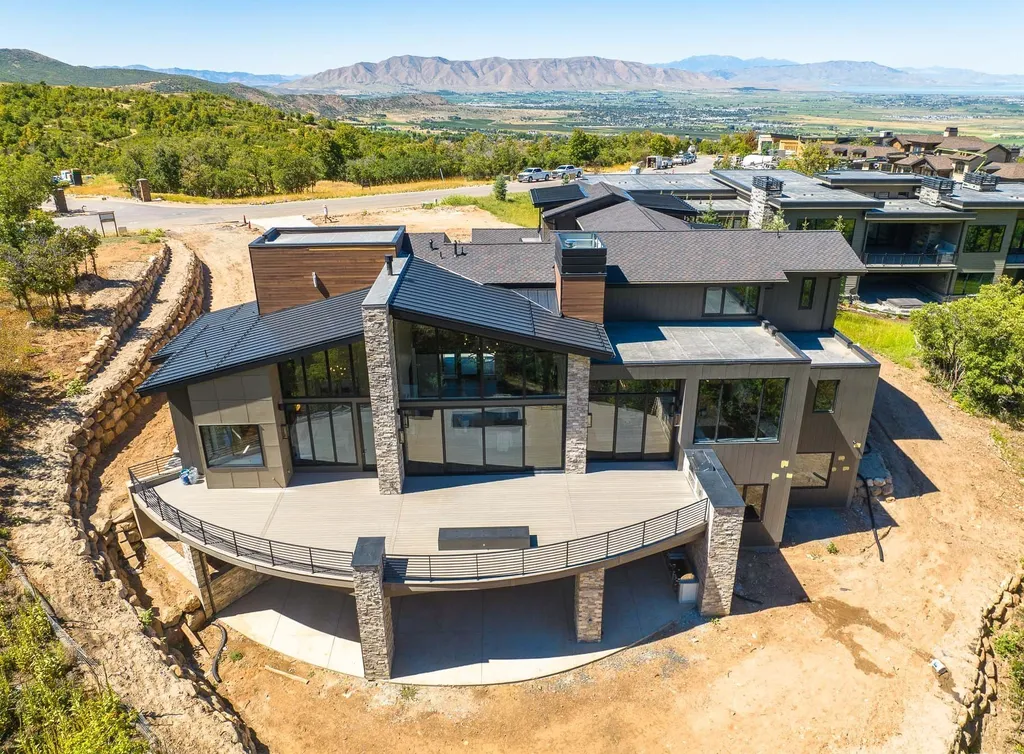 927 South Summit Creek Drive Home in Woodland Hills, Utah. Step into your custom dream home in Summit Creek, offering luxury living and unparalleled natural beauty. This magnificent residence, spanning 8,043 square feet on a .90-acre lot, presents stunning views of mountains and valleys. Floor-to-ceiling windows bathe the open-concept interior in natural light and provide uninterrupted scenic views. 