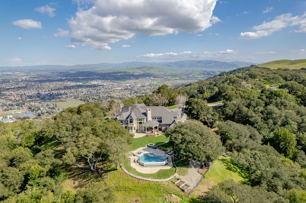 9767 Santos Ranch Road Home in Pleasanton, California. Experience the epitome of wine country living in this 4700+ SF luxury residence by Prodigy Real Estate. Boasting 4 bedrooms, 5 bathrooms, an office, and impeccable craftsmanship, this home offers a thoughtfully designed floor plan, soaring ceilings, and expansive windows to capture panoramic views. 