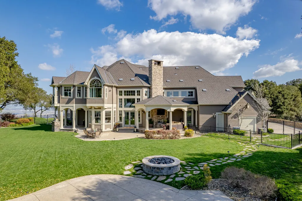 9767 Santos Ranch Road Home in Pleasanton, California. Experience the epitome of wine country living in this 4700+ SF luxury residence by Prodigy Real Estate. Boasting 4 bedrooms, 5 bathrooms, an office, and impeccable craftsmanship, this home offers a thoughtfully designed floor plan, soaring ceilings, and expansive windows to capture panoramic views. 