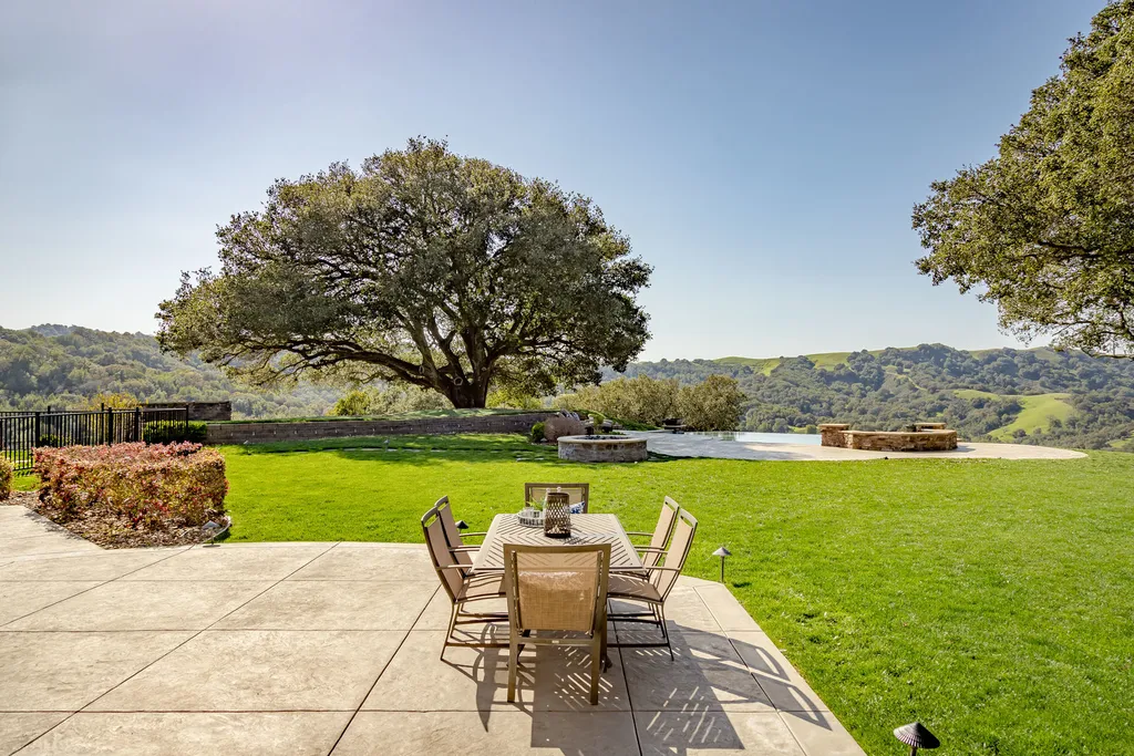 9767 Santos Ranch Road Home in Pleasanton, California. Experience the epitome of wine country living in this 4700+ SF luxury residence by Prodigy Real Estate. Boasting 4 bedrooms, 5 bathrooms, an office, and impeccable craftsmanship, this home offers a thoughtfully designed floor plan, soaring ceilings, and expansive windows to capture panoramic views. 