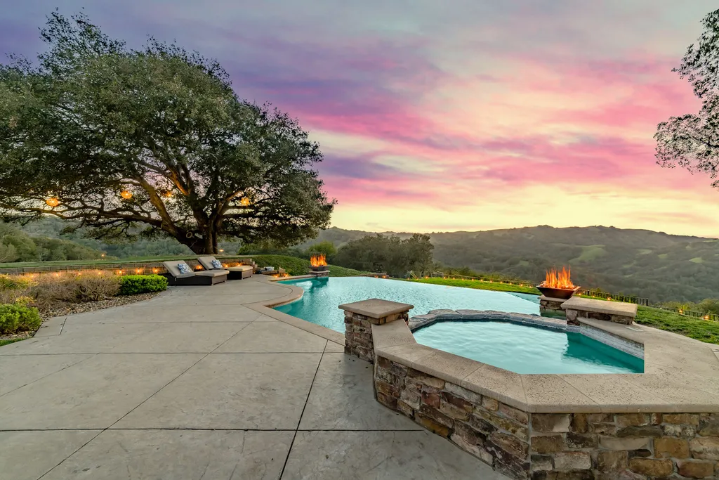 9767 Santos Ranch Road Home in Pleasanton, California. Experience the epitome of wine country living in this 4700+ SF luxury residence by Prodigy Real Estate. Boasting 4 bedrooms, 5 bathrooms, an office, and impeccable craftsmanship, this home offers a thoughtfully designed floor plan, soaring ceilings, and expansive windows to capture panoramic views. 