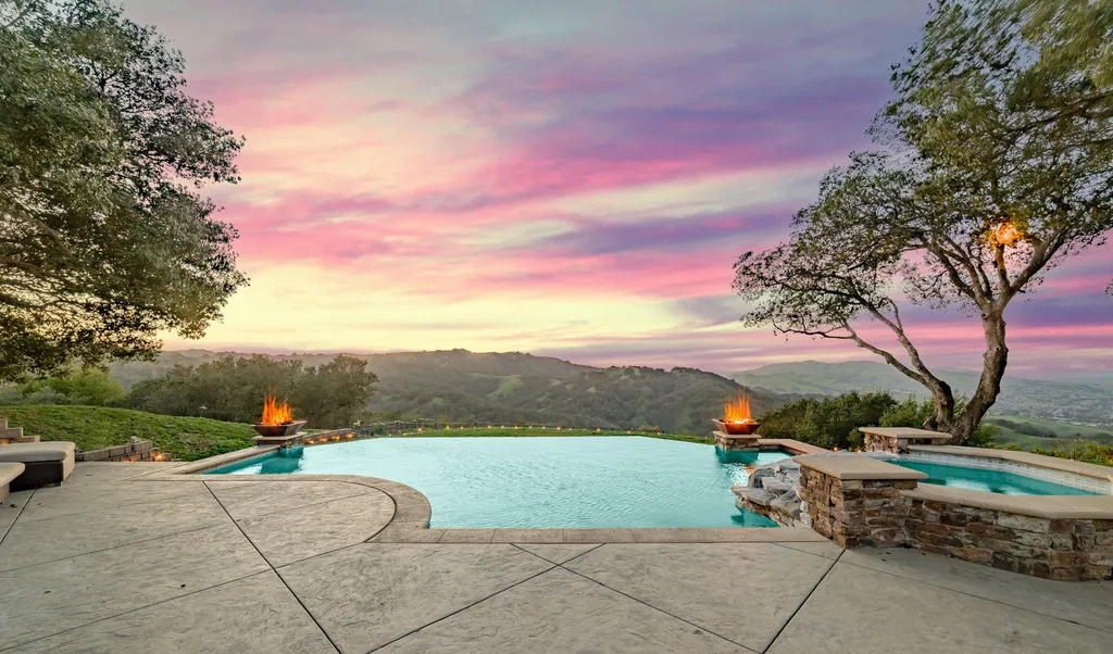 9767 Santos Ranch Road Home in Pleasanton, California. Experience the epitome of wine country living in this 4700+ SF luxury residence by Prodigy Real Estate. Boasting 4 bedrooms, 5 bathrooms, an office, and impeccable craftsmanship, this home offers a thoughtfully designed floor plan, soaring ceilings, and expansive windows to capture panoramic views. 