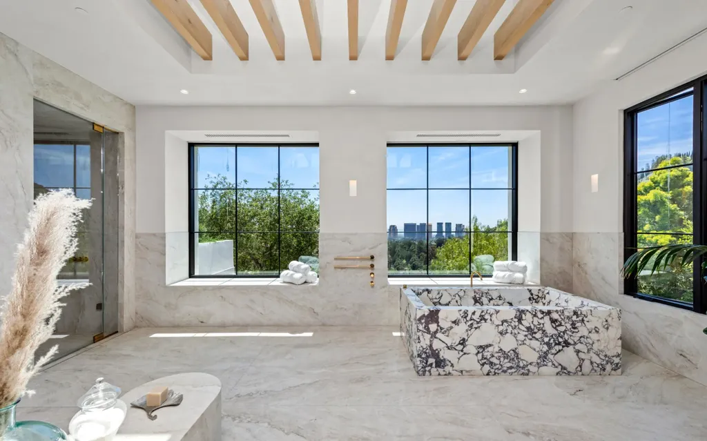 9904 Kip Drive Home in Beverly Hills, California. Enter the world of opulence and exclusivity with this celebrity compound behind gated privacy. Designed by KAA Associates, the 25,000 SF estate boasts 7 bedrooms, 13 bathrooms, lush gardens, and stunning canyon, city, and ocean views. 
