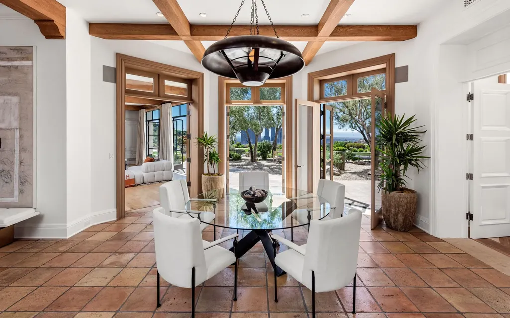 9904 Kip Drive Home in Beverly Hills, California. Enter the world of opulence and exclusivity with this celebrity compound behind gated privacy. Designed by KAA Associates, the 25,000 SF estate boasts 7 bedrooms, 13 bathrooms, lush gardens, and stunning canyon, city, and ocean views. 